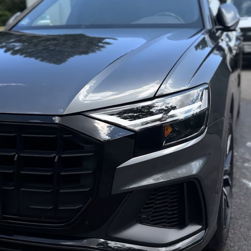 Grey Audi Q8 front grille and headlight after an exterior detail and gloss enhancement